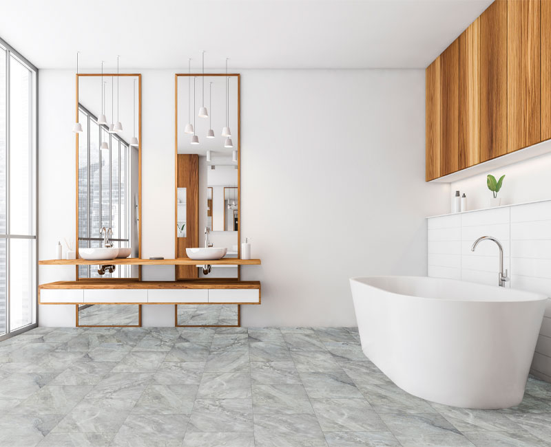 stone look luxury vinyl tile flooring in bathroom with wood accent and white bathtub.